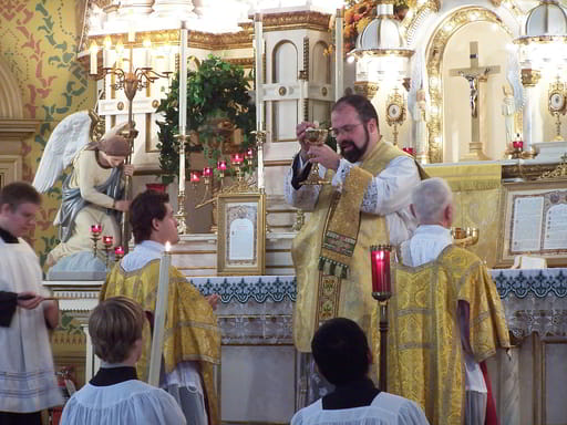 At a Solemn Tridentine Mass, the Host is displayed to the people